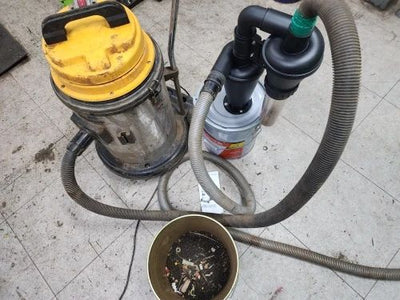 Dust and debris around a shop vacuum connection